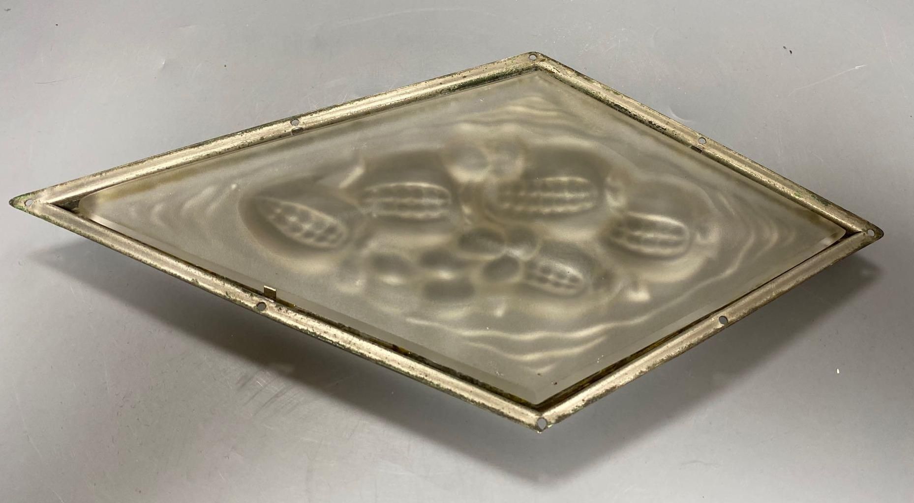 A pressed, frosted glass lozenge shape panel, within brass frame, height 35cm